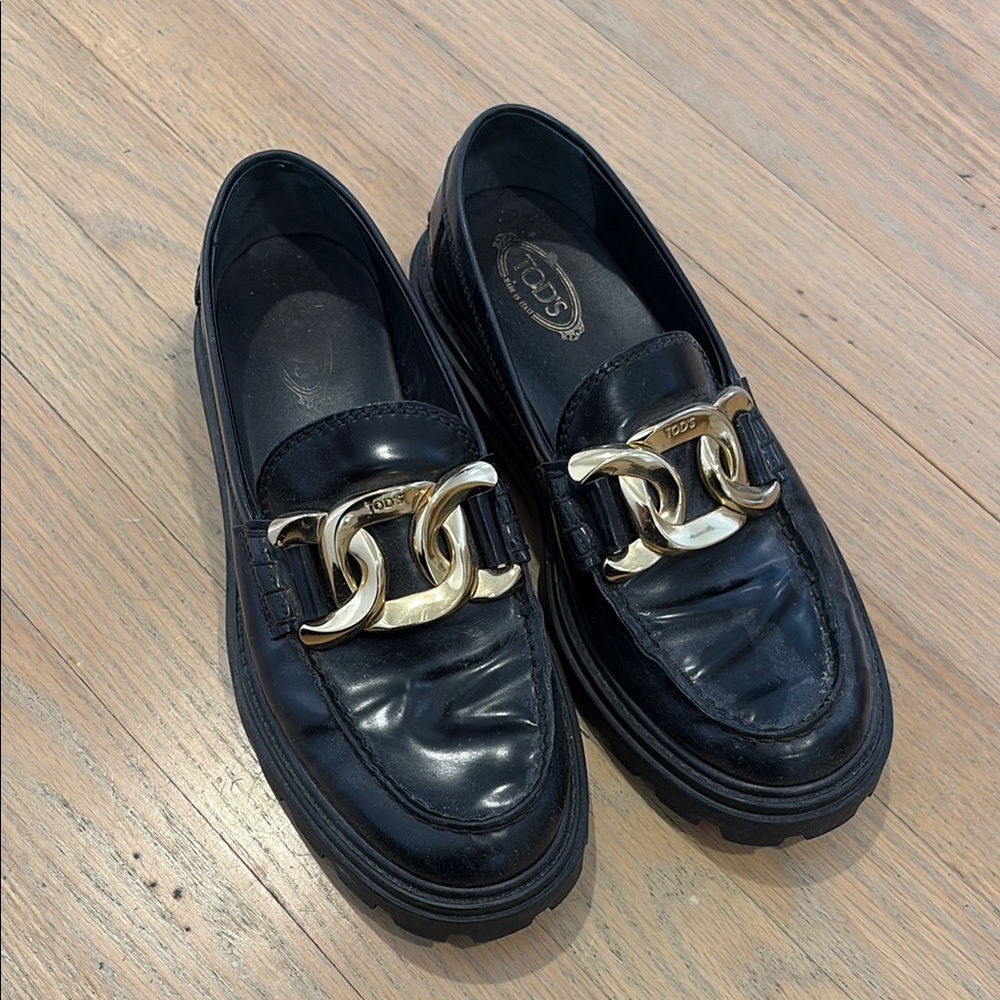 Tod's Elegant Black Loafers with Gold Accent